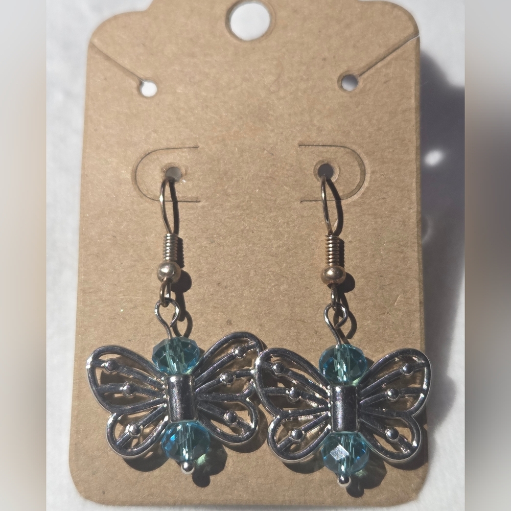 Butterfly earrings Teal beads with Silver dangle hooks.".